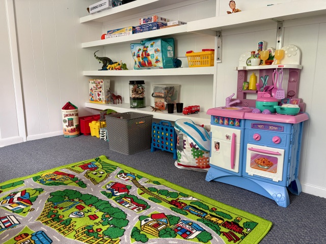 Children anxiety therapy play room with toys and activity rug